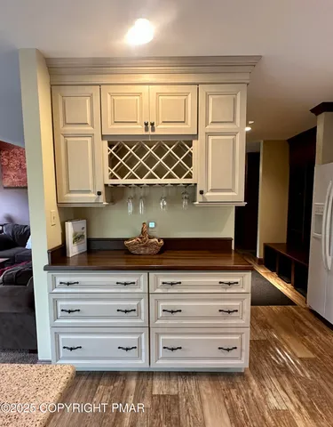 a kitchen with granite countertop white cabinets and sink