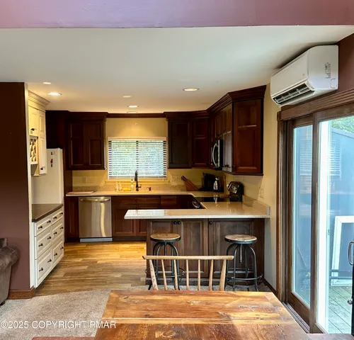 a kitchen with stainless steel appliances granite countertop a stove a sink and a refrigerator