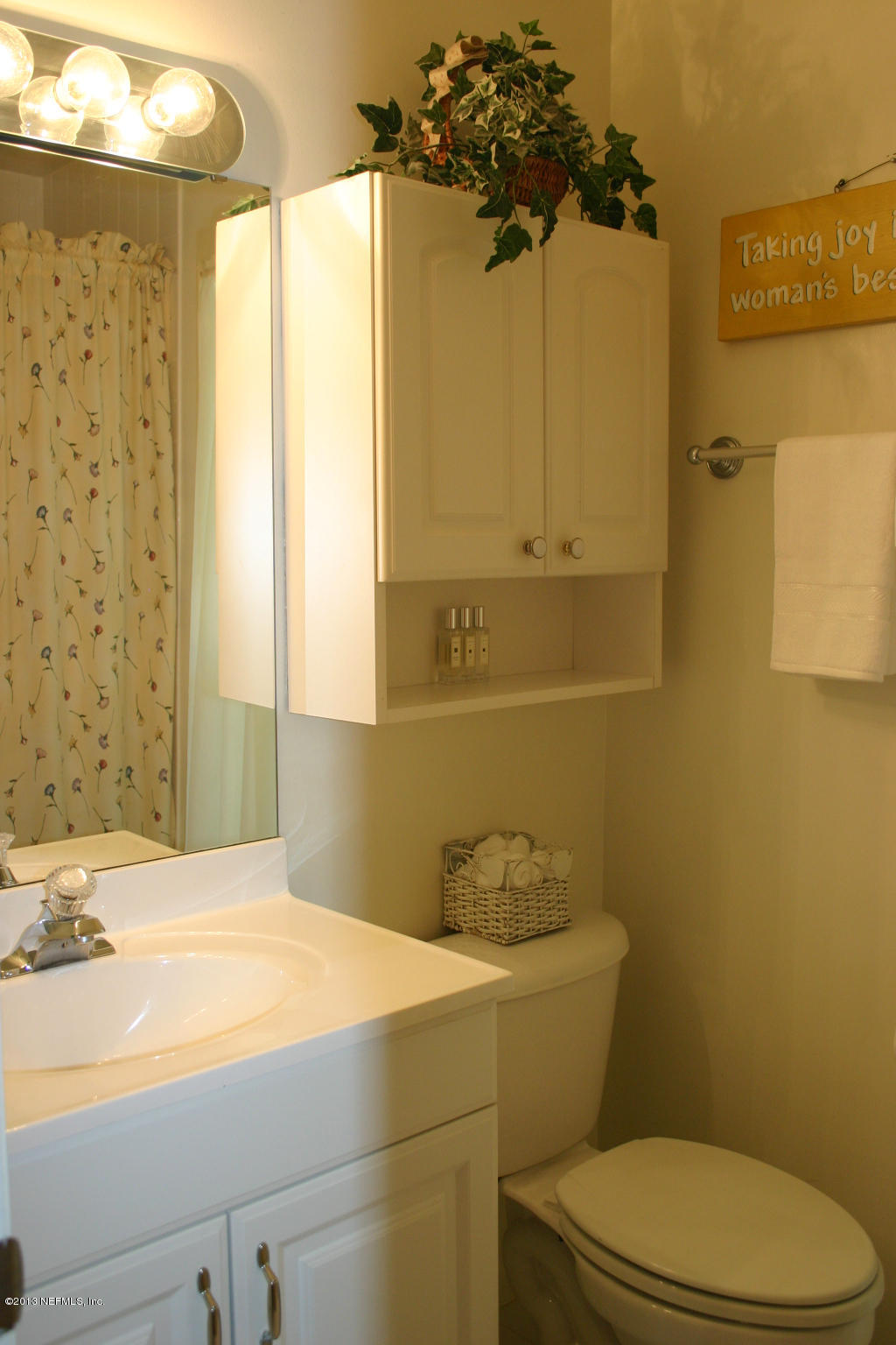 3969 Heidi Road Jacksonville, FL 32277 - Photo 13 of 29 a bathroom with a sink a toilet and shower curtain