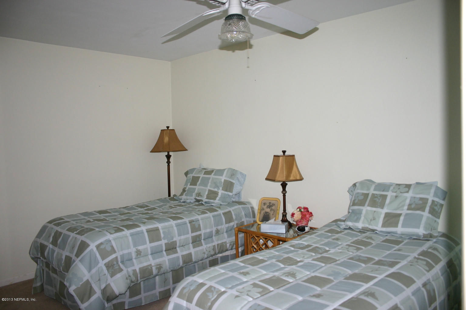 3969 Heidi Road Jacksonville, FL 32277 - Photo 17 of 29 a bedroom with a bed and a chandelier