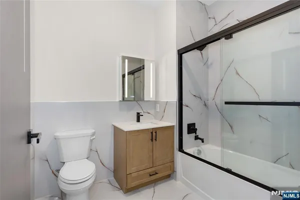 a bathroom with a toilet sink and mirror