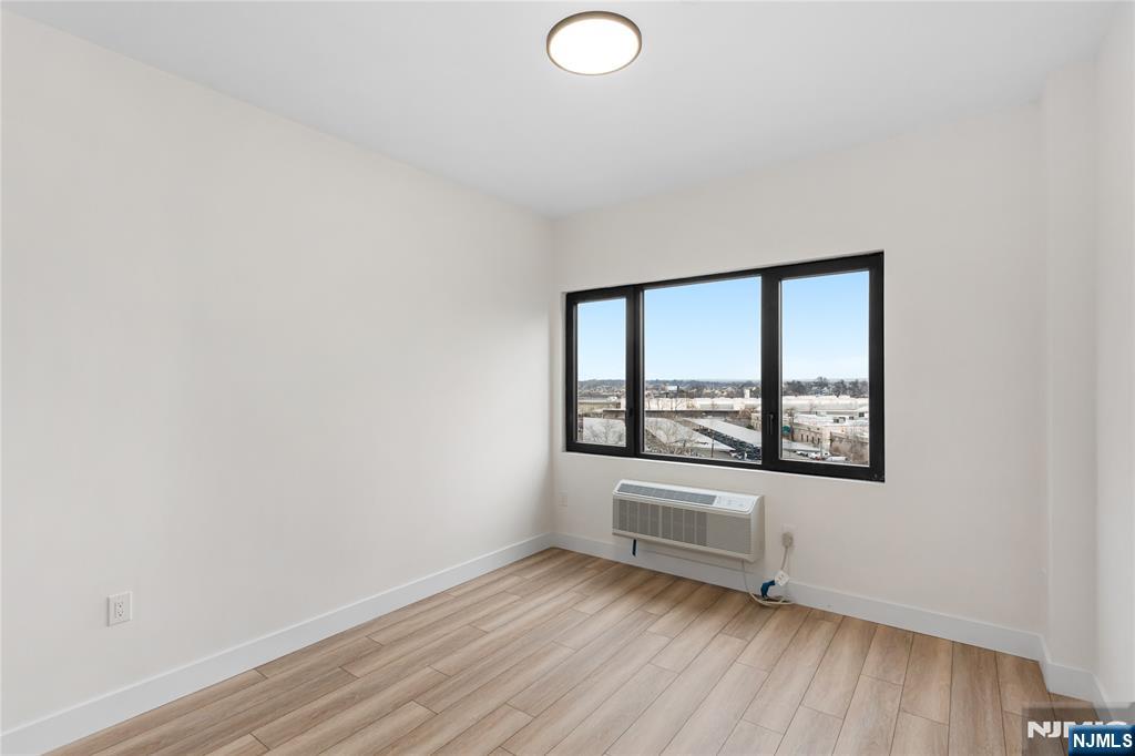 89 Mary Street, Unit 504 Paterson, NJ 07503 - Photo 7 of 10 wooden floor in an empty room with a window