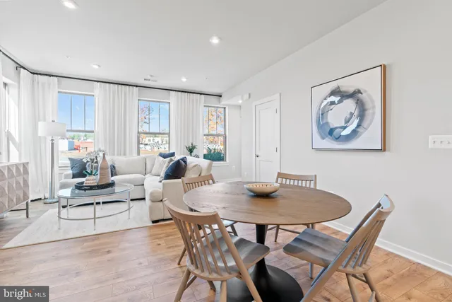 a view of a dining room with furniture and wooden floor