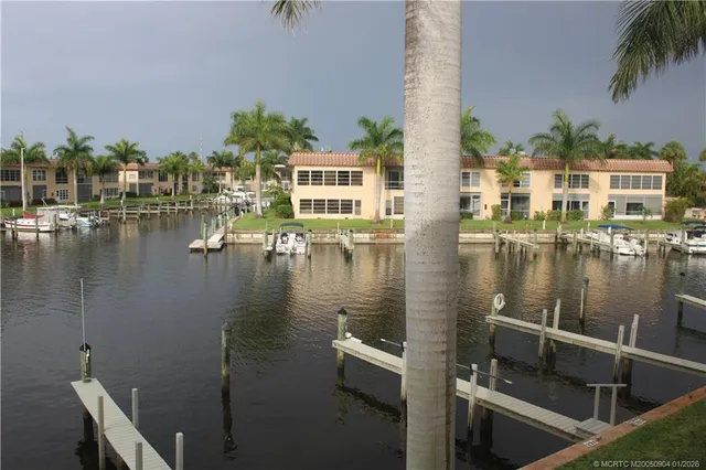 a view of house with yard and lake view