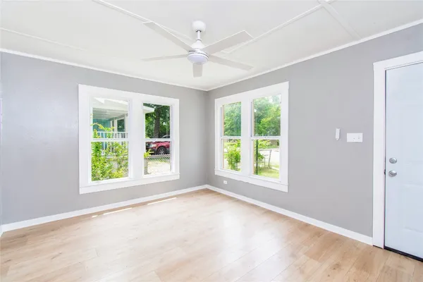 an empty room with windows and closet