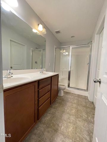 a bathroom with a sink a mirror and a shower