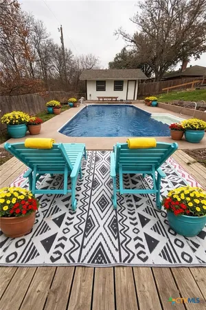 swimming pool view with an outdoor seating