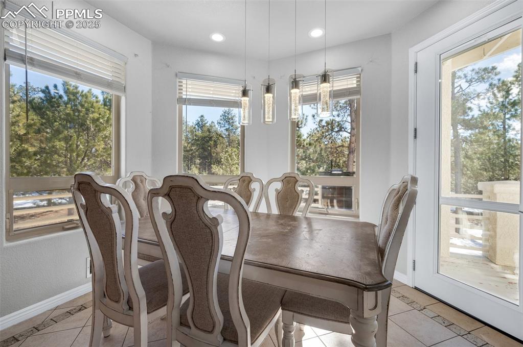 17502 Abert Ridge View Colorado Springs, CO 80908 - Photo 12 of 50 Dining space with light tile patterned flooring, recessed lighting, and baseboards