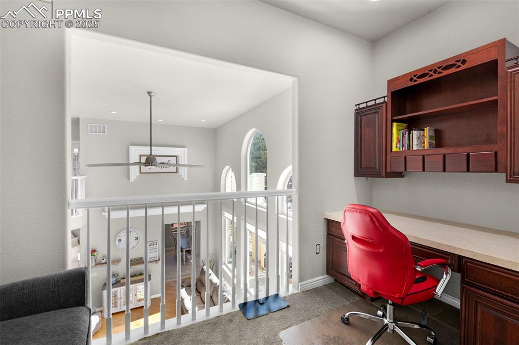 17502 Abert Ridge View Colorado Springs, CO 80908 - Photo 23 of 50 Carpeted office featuring visible vents, baseboards, a ceiling fan, and built in desk