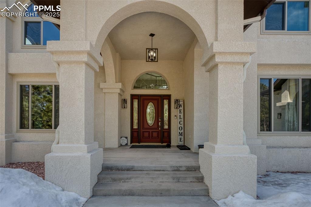 17502 Abert Ridge View Colorado Springs, CO 80908 - Photo 3 of 50 Property entrance featuring stucco siding