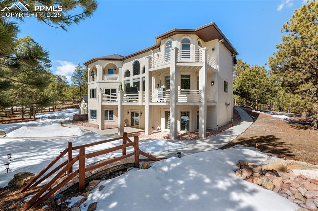 17502 Abert Ridge View Colorado Springs, CO 80908 - Photo 40 of 50 Snow covered house with a balcony and stucco siding
