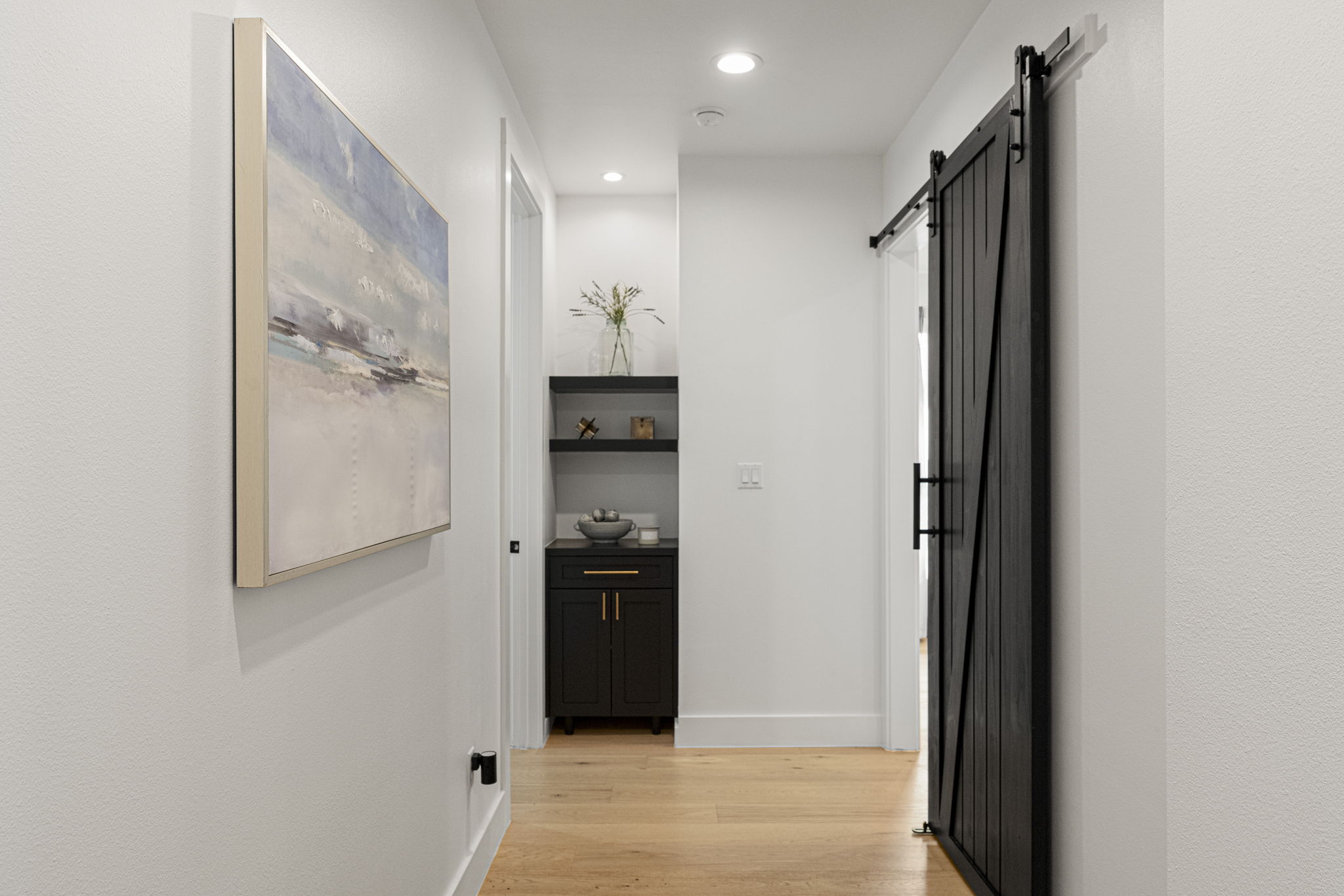 32831 Ranch Road 12 Dripping Springs, TX 78620 - Photo 21 of 40 Hallway leading to the game room with a nice sized barn door to close it off when needed