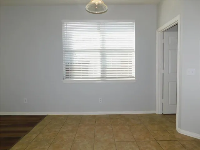 a view of a room with wooden floor and a fireplace
