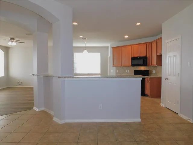 a view of a kitchen with a sink cabinets and a fireplace