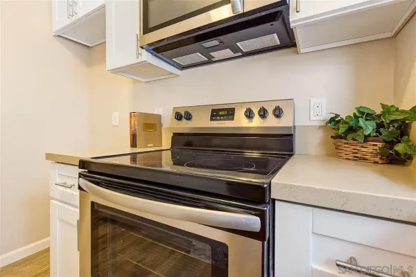 a stove top oven sitting inside of a kitchen