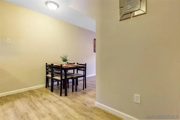 a view of a room with furniture and wooden floor