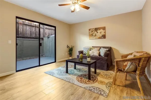 a living room with furniture and a glass window