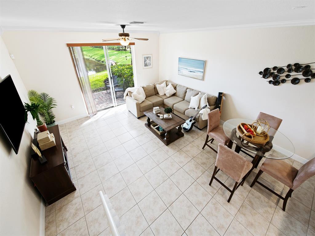 4792 Sundance Way, Unit 4792 Davie, FL 33328 - Photo 14 of 28 a living room with furniture floor to ceiling window and a potted plant