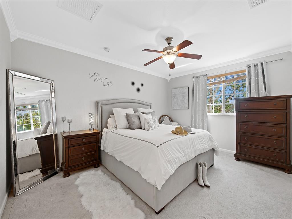 4792 Sundance Way, Unit 4792 Davie, FL 33328 - Photo 16 of 28 a bedroom with a bed a dresser and a window