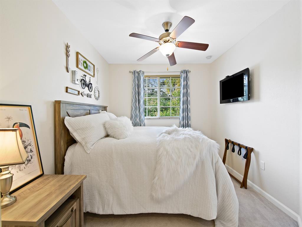 4792 Sundance Way, Unit 4792 Davie, FL 33328 - Photo 21 of 28 a bedroom with a bed and a flat screen tv