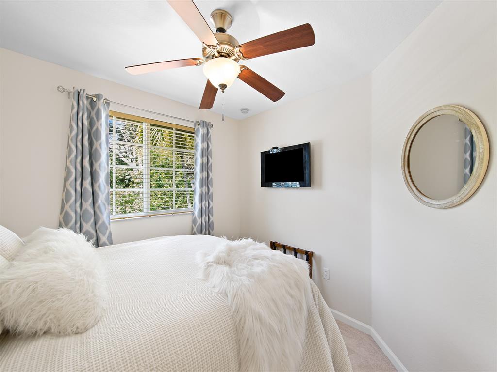 4792 Sundance Way, Unit 4792 Davie, FL 33328 - Photo 25 of 33 a bedroom with a bed and a flat screen tv