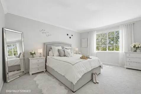 a bedroom with a large bed and a window