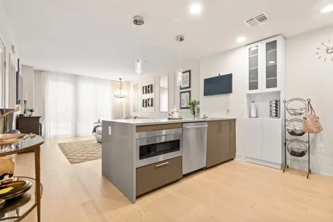 a kitchen with kitchen island a sink stove and oven