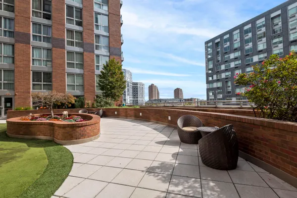 a view of tall buildings and a yard
