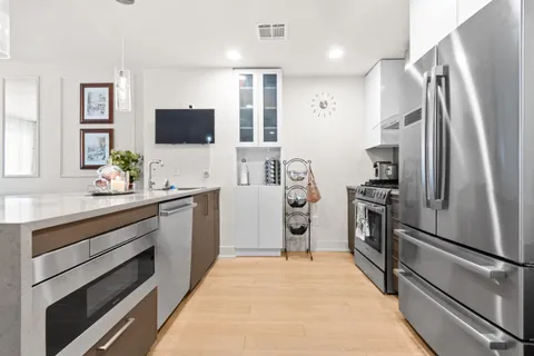 a kitchen with stainless steel appliances a refrigerator stove and sink