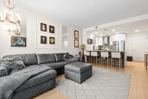 a living room with furniture and kitchen view