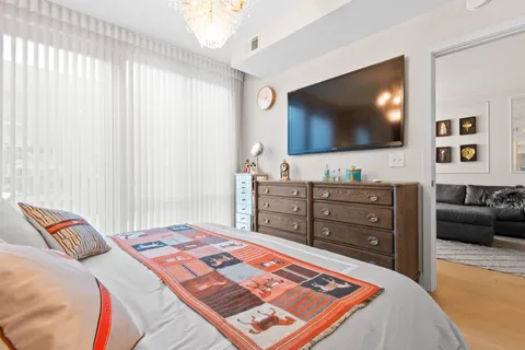 a bedroom with a bed and a flat screen tv
