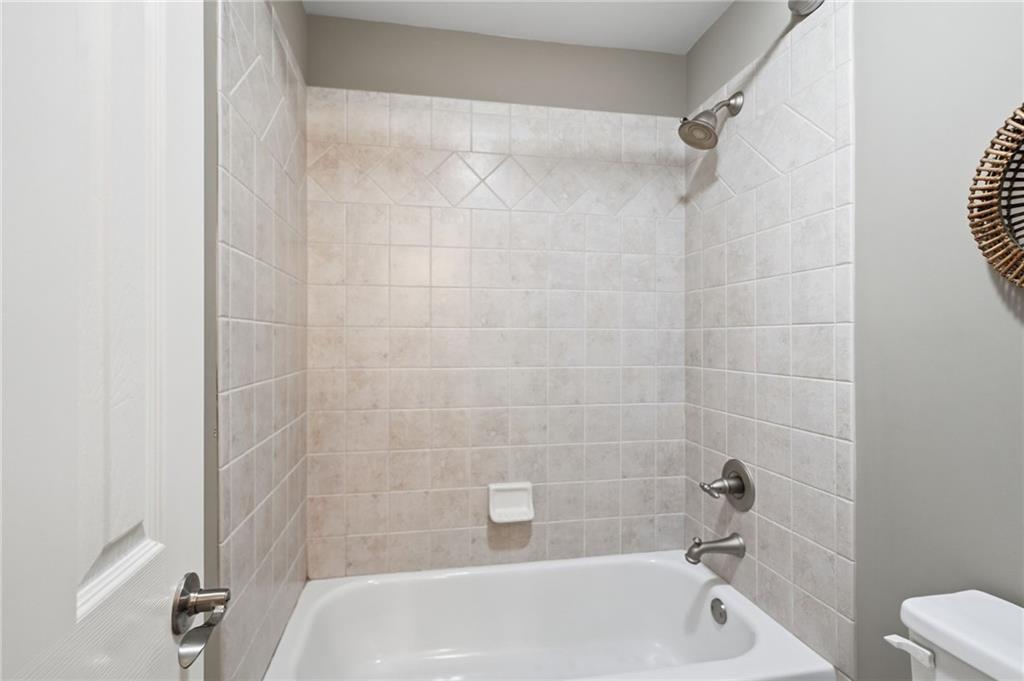 4147 Gold Mill Ridge Canton, GA 30114 - Photo 40 of 93 a bathroom with a shower and a bathtub