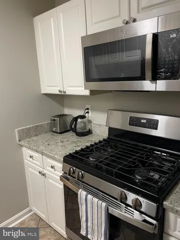 a stove top oven sitting inside of a kitchen