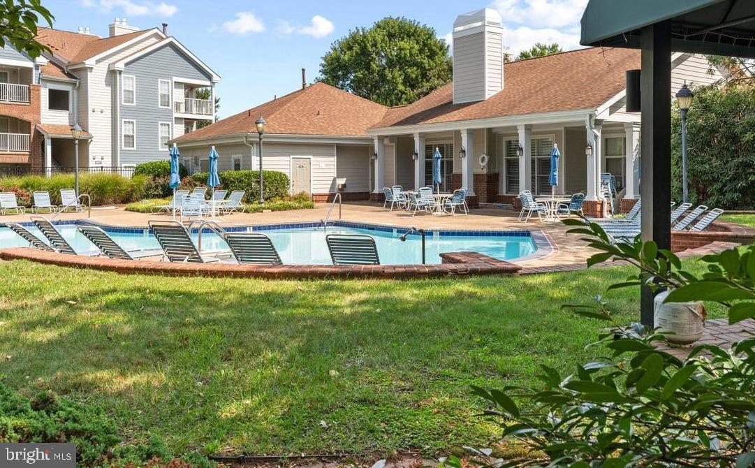 21012 Timber Ridge Terrace, Unit 201 Ashburn, VA 20147 - Photo 37 of 37 a view of a white house with a large pool table and chairs