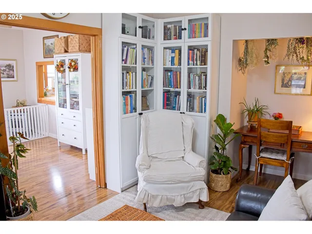 a living room with furniture and a book shelf
