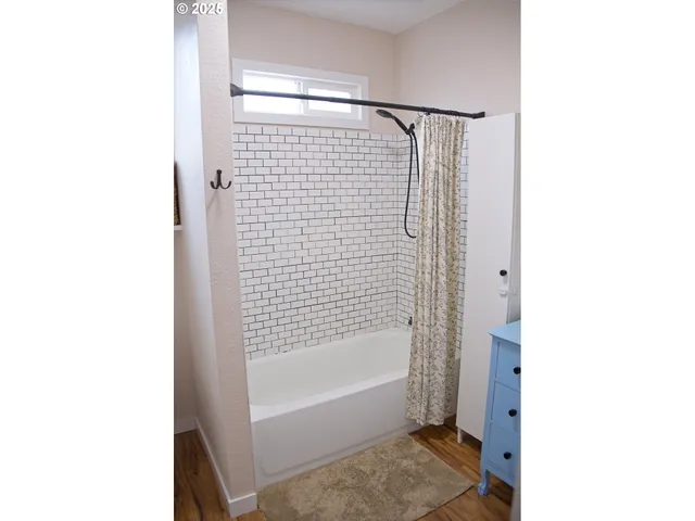 a bathroom with a bathtub and a shower