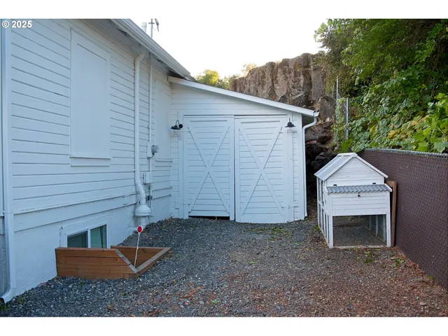 a backyard of a house with yard and garage