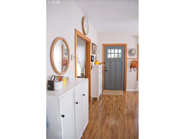 a view of a hallway with wooden floor