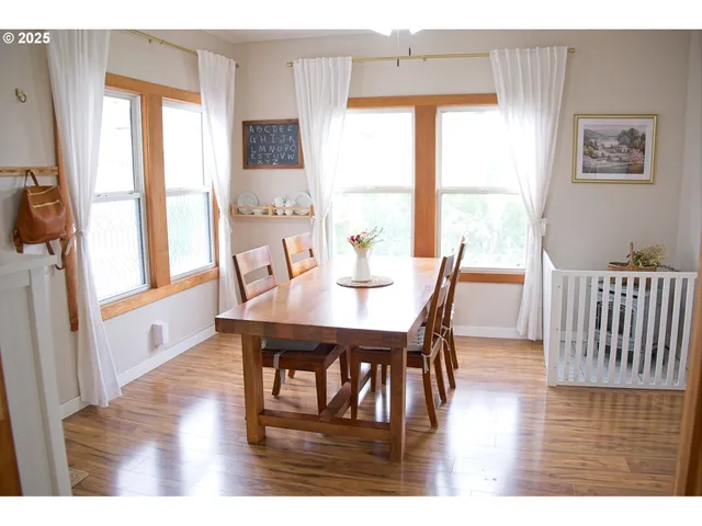 a view of a dining room with furniture and wooden floor