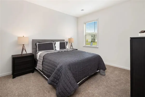 a bed sitting in a bedroom next to a window