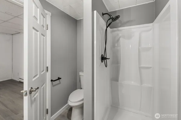 a bathroom with a granite countertop shower and a toilet