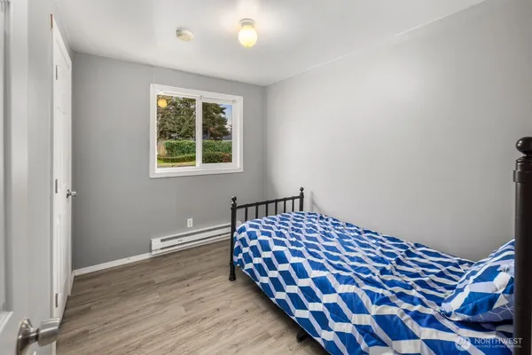 a bedroom with a bed and a window