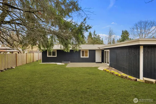 a backyard of a house with large trees