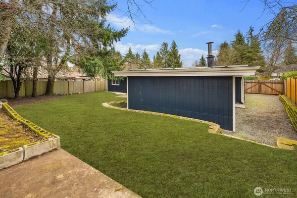 a view of a backyard with large trees