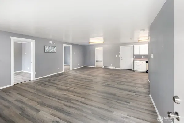a view of empty room with wooden floor