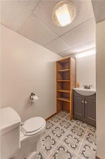 a bathroom with a toilet sink and mirror