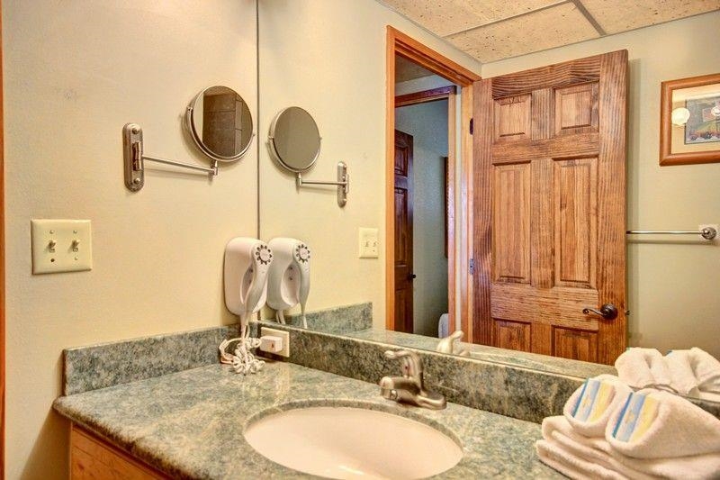 3445 Lower Honoapiilani Road, Unit 255 Lahaina, HI 96761 - Photo 20 of 35 a bathroom with a granite countertop sink and a mirror
