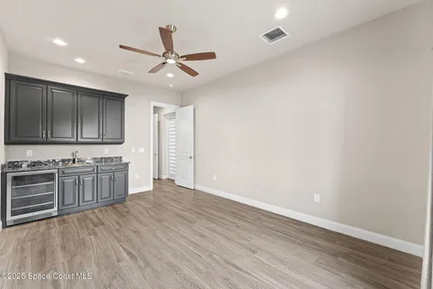 a view of a kitchen with a sink cabinets and wooden floor