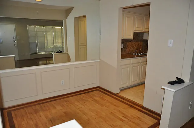a view of a bedroom with wooden floor and cabinet