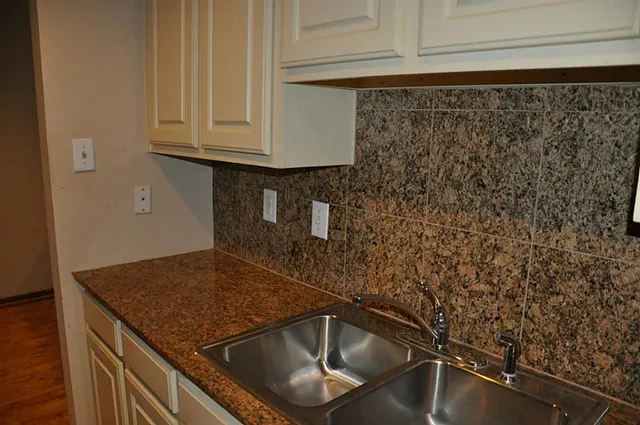 a kitchen with a sink and cabinets